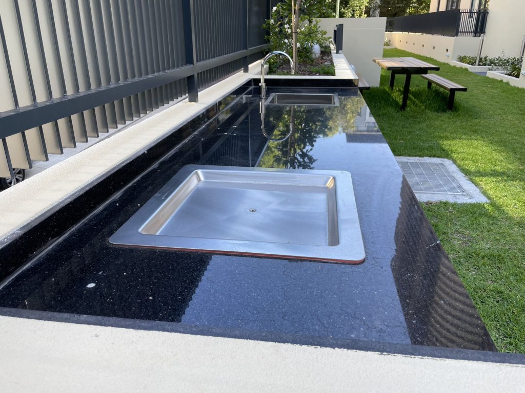 Inbench Greenplate BBQ installed in custom granite cabinet